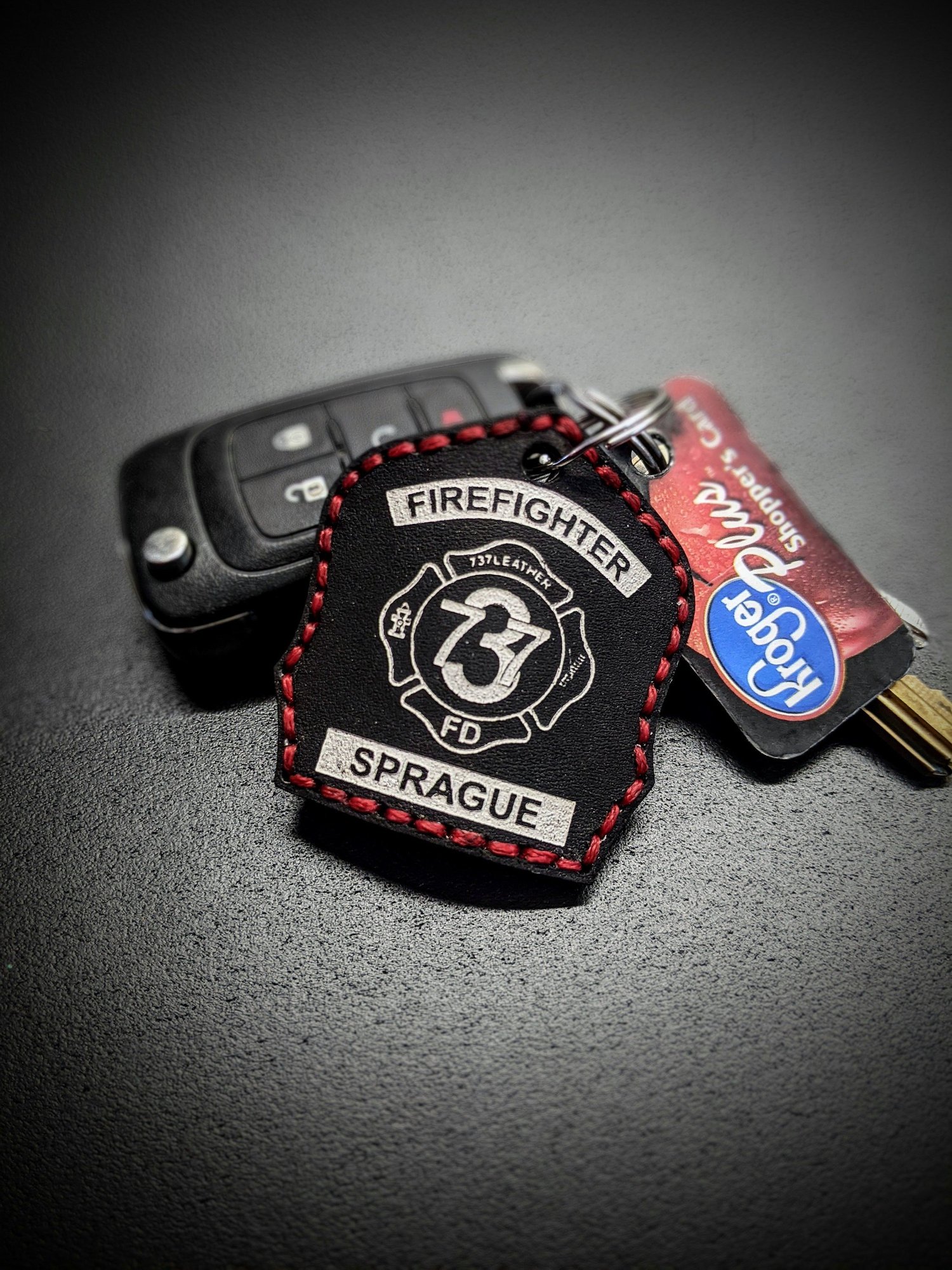 Custom black leather firefighter helmet shield keychain with personalized station number