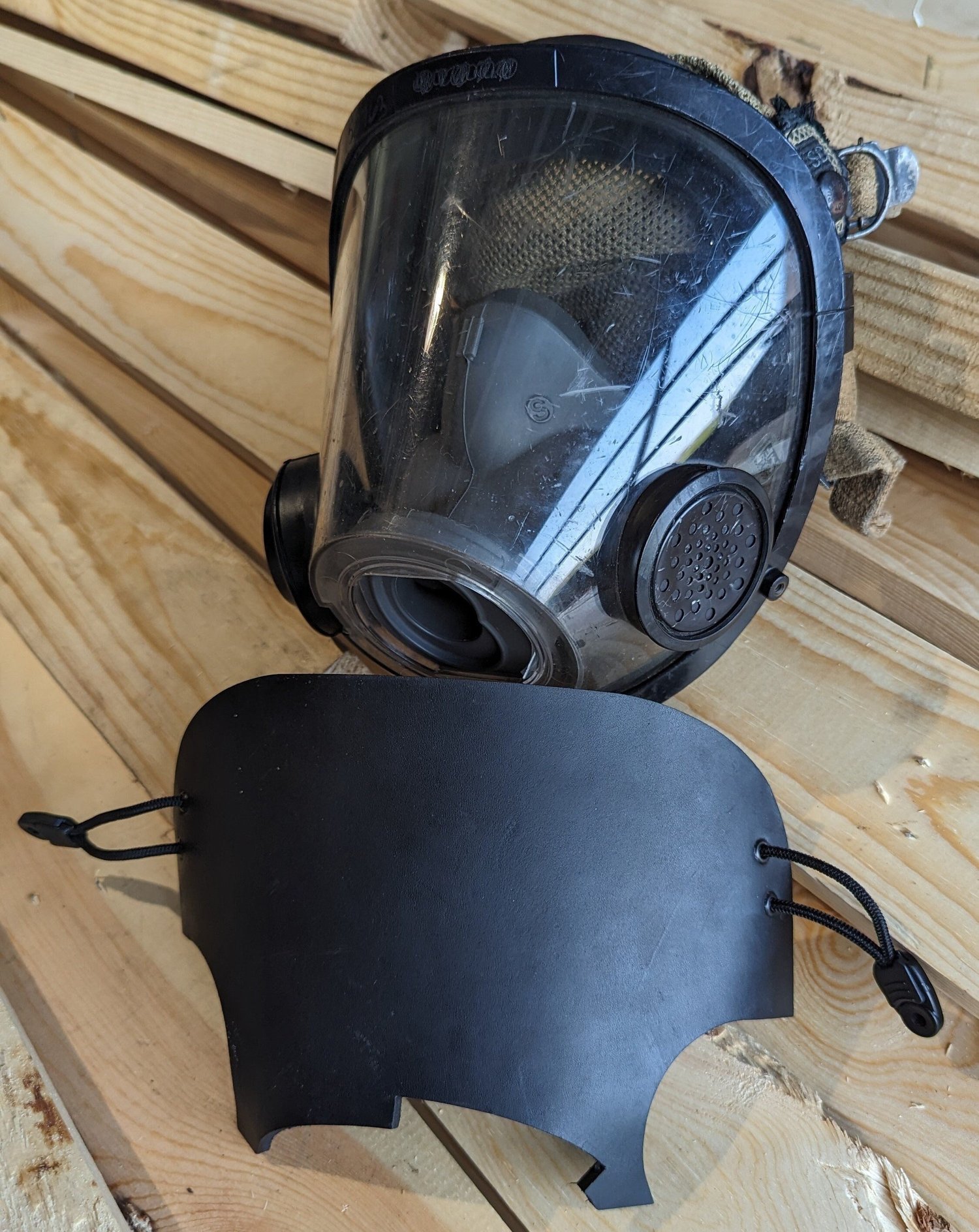 Black leather blackout training SCBA mask cover fitted to a Scott AV-3000 facepiece