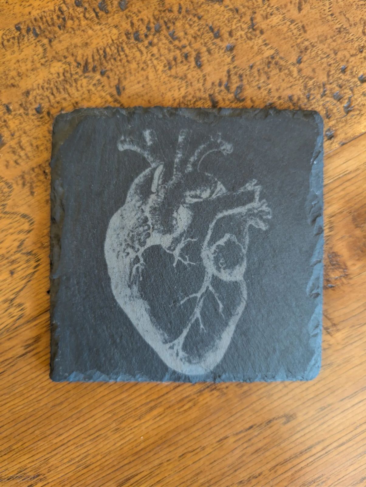 Natural slate coaster laser engraved with a detailed anatomical heart
